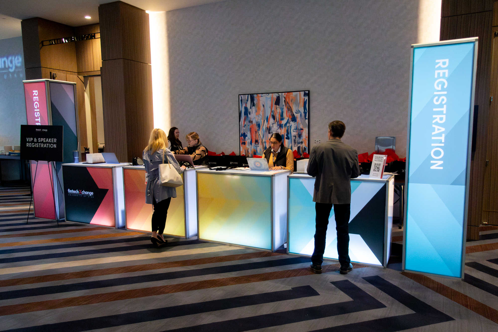 Event registration counters with branded graphics and signage