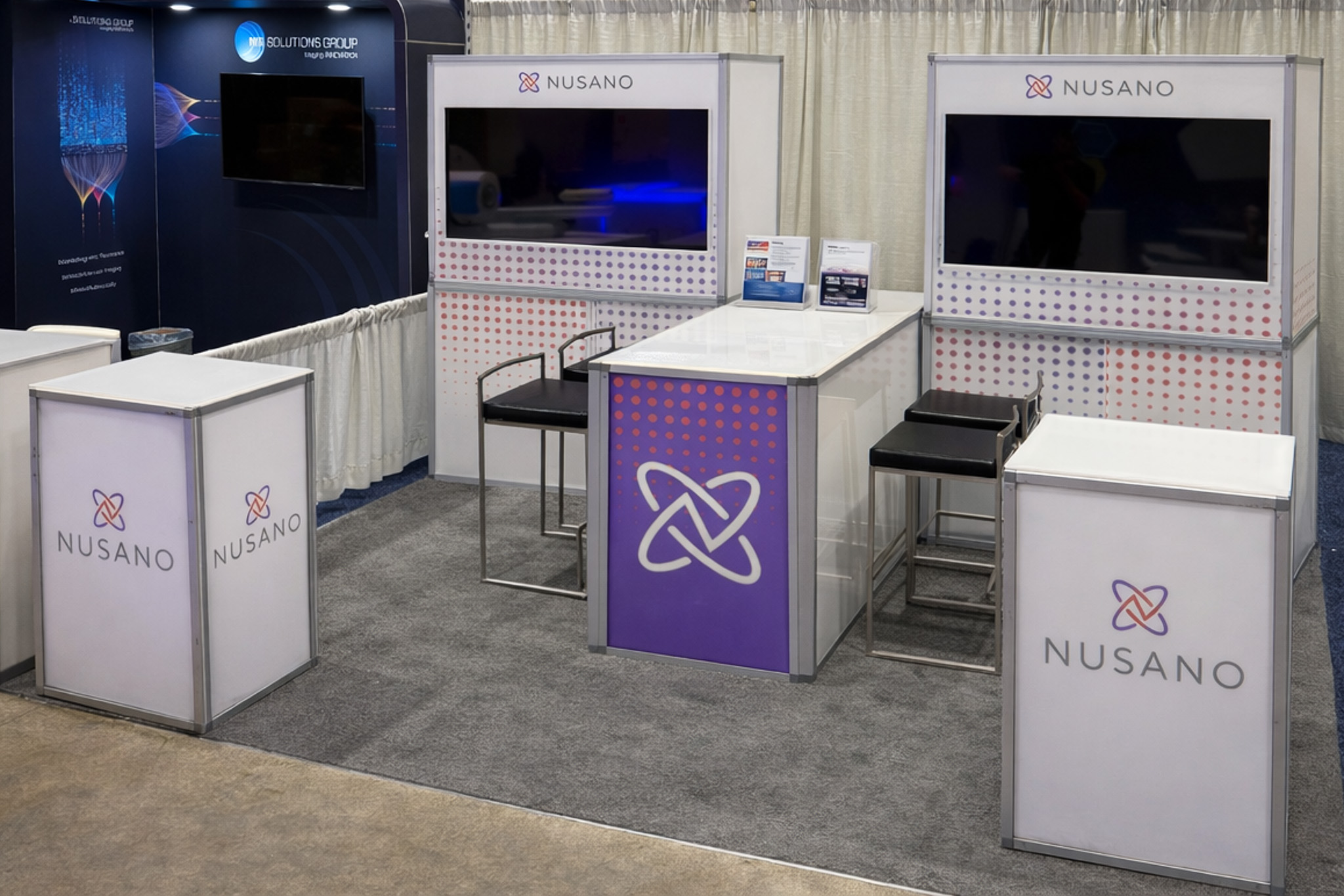 Trade show booth display with mannequins and large branded backdrop