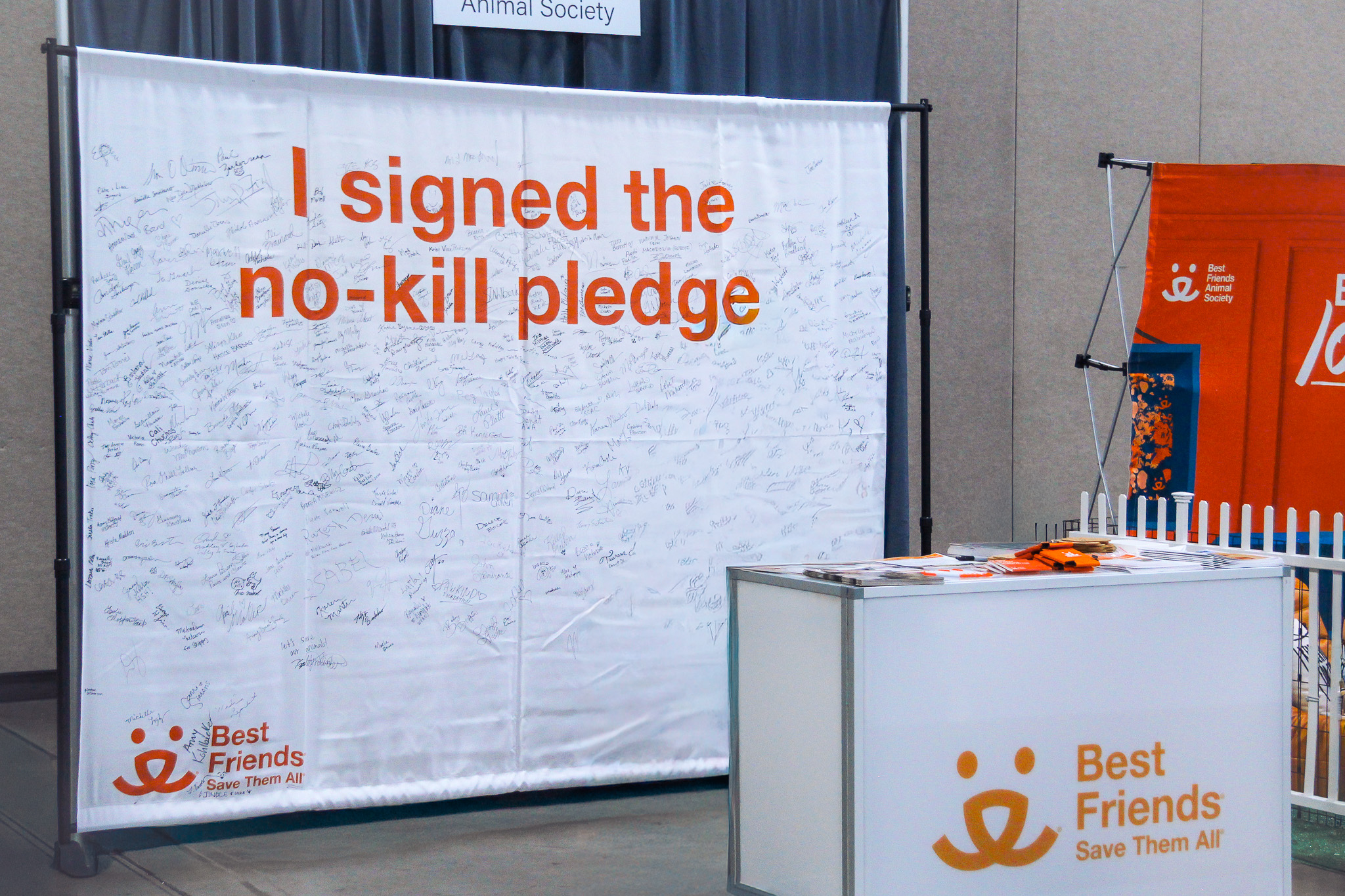 Mannequins in front of branded trade show wall graphics